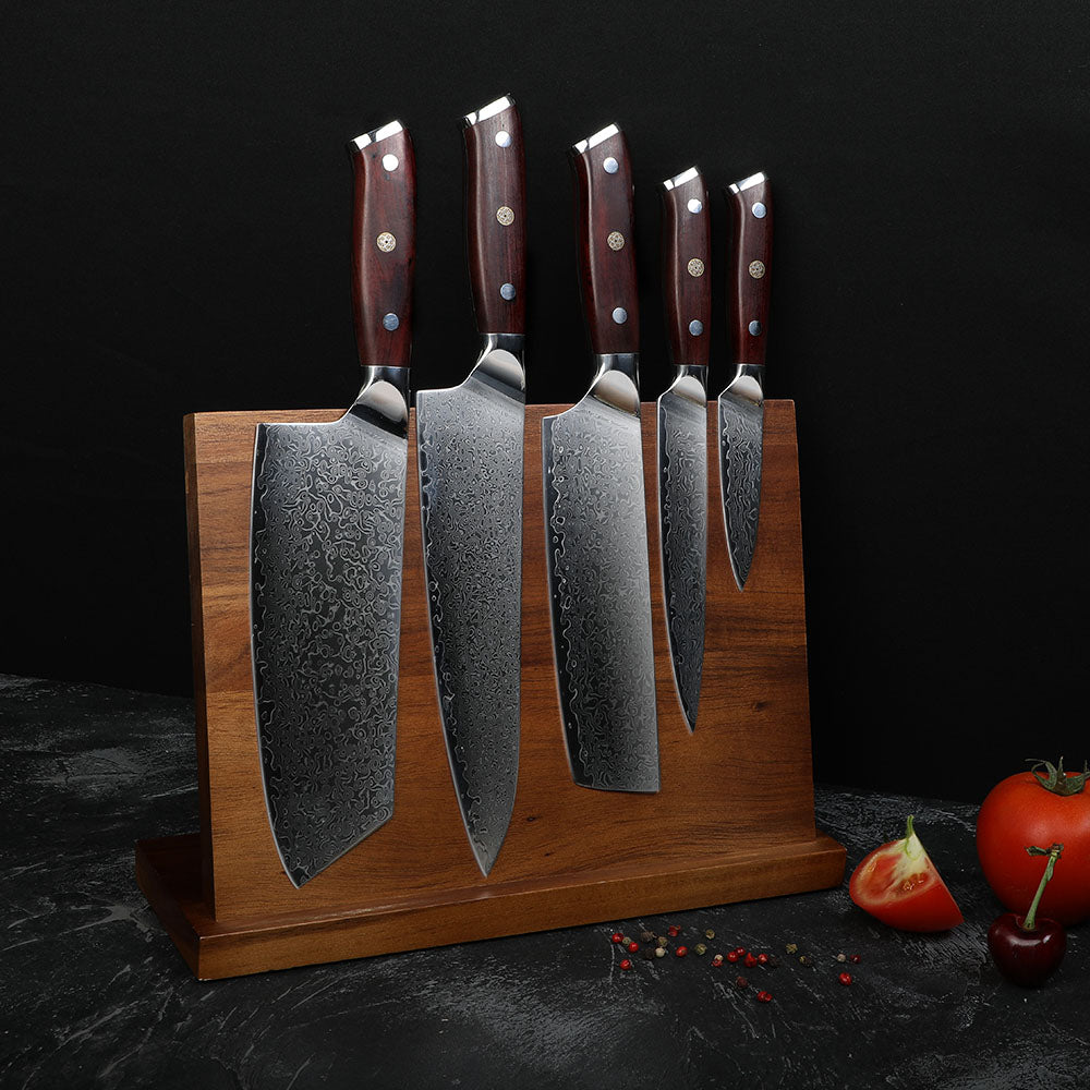 Set of five knives on a wooden stand with a dark background