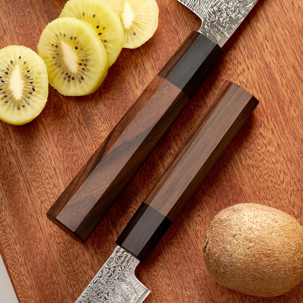 Wooden-handled knife with a sheath on a wooden surface next to sliced kiwis and a whole kiwi.