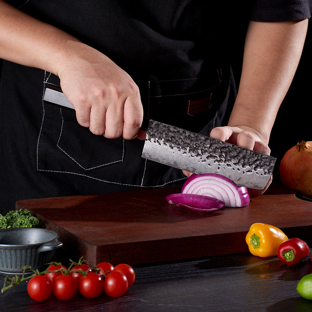 Prfofessional chef with Nakiri Damascus Japanese knife cuts onions