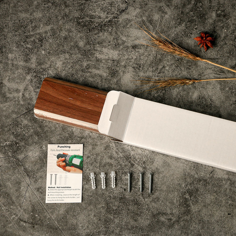 The box of a wall-mounted magnetic knife holder in a kitchen setting, showing everything included in the box and assembly information.