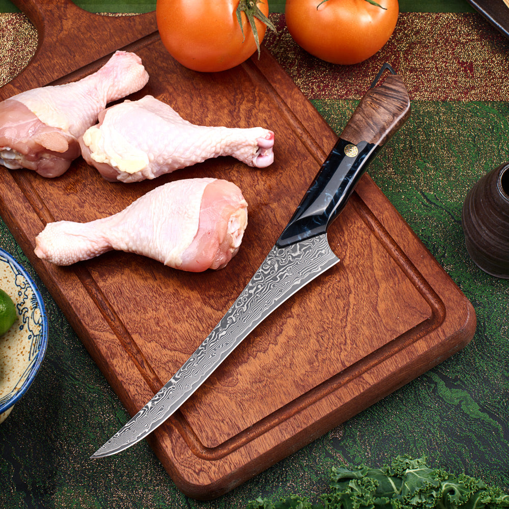 Decorative knife on a wooden cutting board with raw chicken drumsticks and tomatoes.